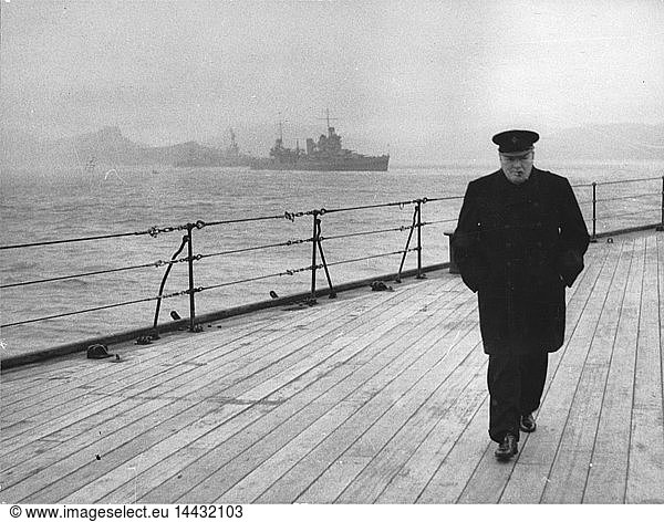 World War II: Winston Spencer Churchill (1874-1965) British statesman  in overcoat and hat and smoking a cigar  walking alone on the deck of HMS "Prince of Wales" during the Atlantic Conference  1941.