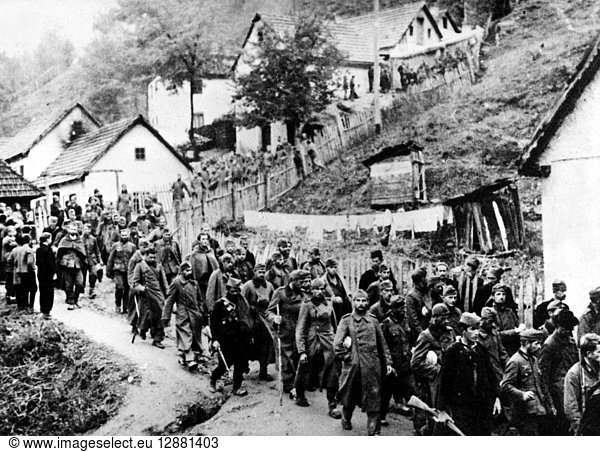 WORLD WAR II: YUGOSLAVIA. German prisoners of war forced to march by their Partisan captors in Uzice (in modern Serbia)  a city liberated from Axis control. Photographed 1941.