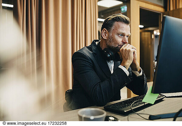Worried businessman working on computer in office