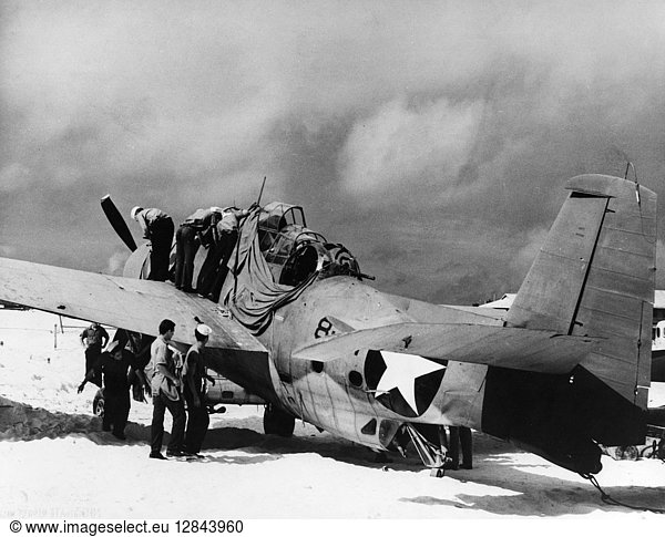 WWII: BATTLE OF MIDWAY  1942. American crewmen working on a Grumman TBF 'Avenger' torpedo bomber  damaged during the Battle of Midway. Photograph  June 1942.