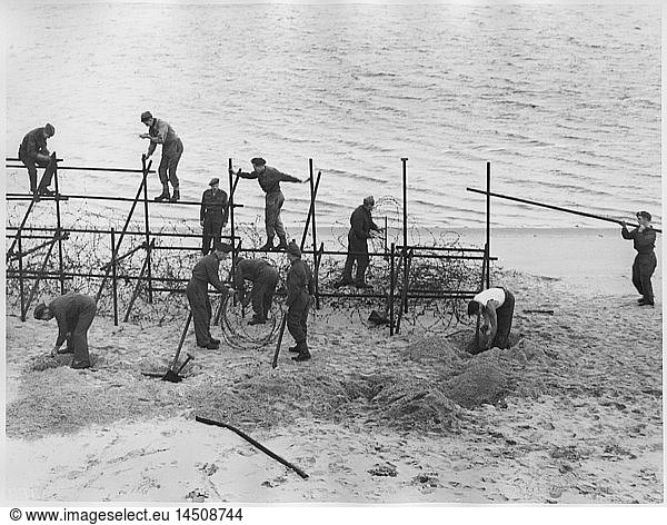 WWII Soldiers Constructing Barricade on Beach  From the British Documentary Film  A Diary for Timothy  1945