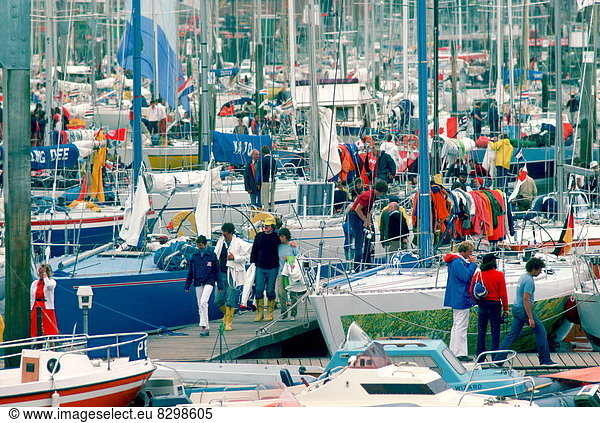 Yachting people at yachting marina in Cowes  Isle of Wight during the famous Cowes Week in August.