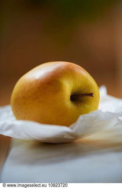 Yellow apple on greaseproof paper