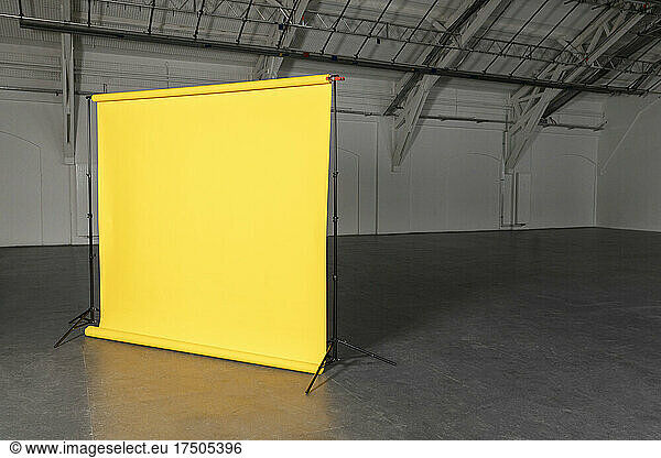 Yellow backdrop at empty industrial hall