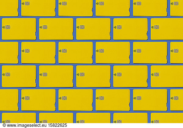Yellow contactless credit cards pattern on blue background