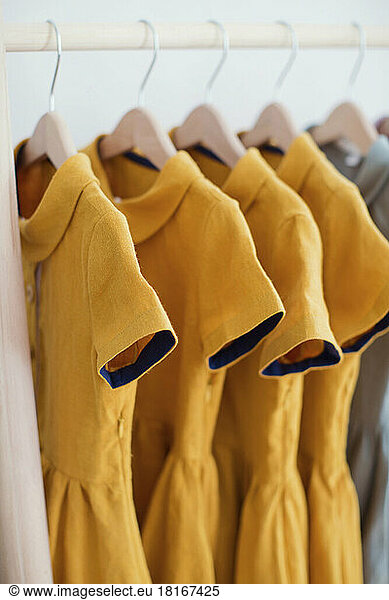 Yellow dresses hanging on coathanger