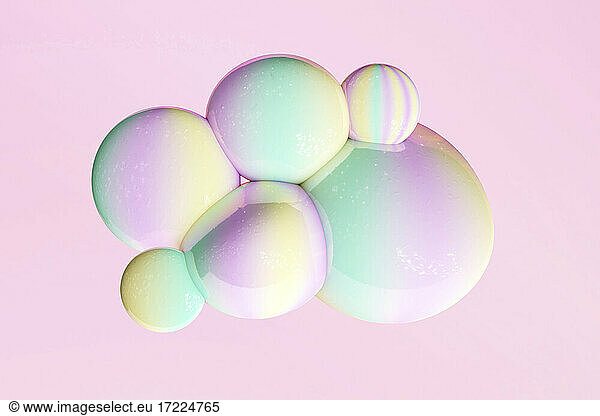 Yellow  green and pink pastel bubbles against pink background