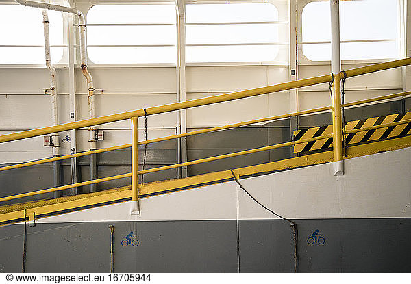 Yellow hand rail on ferry boat ramp