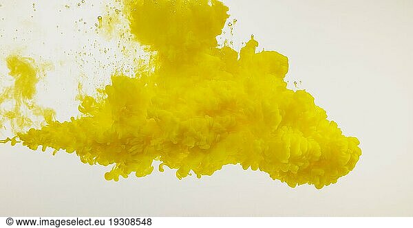 Yellow Ink entering Water against white Background
