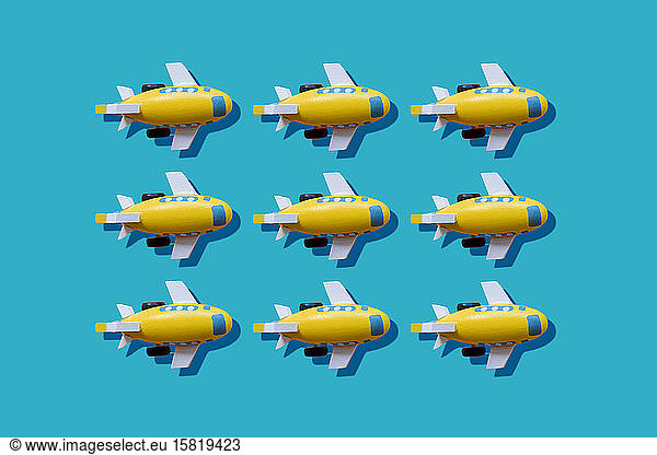 Yellow planes in a row on blue background