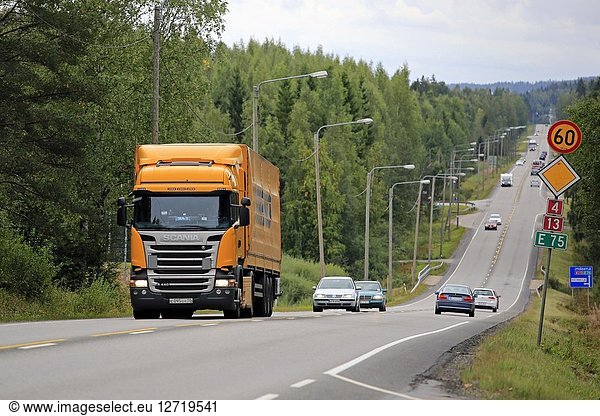 Yellow Scania R440 semi trailer of Trasko hauls goods on highway E18 on an overcast day of late summer in Jyvaskyla  Finland - August 26  2018.