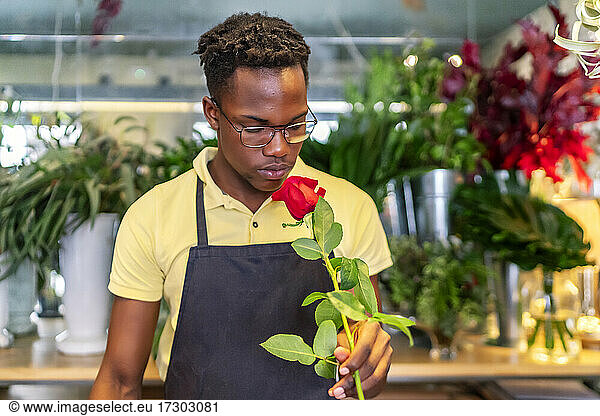 young african entrepreneur smelling the flowers of his business