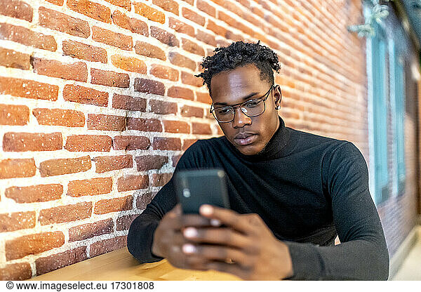 young african man working from his smartphone