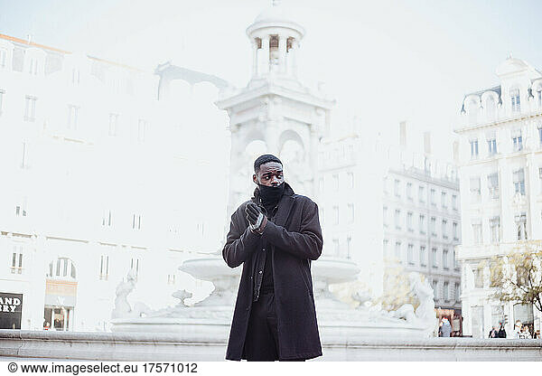 young afro man in france walking outside in winter