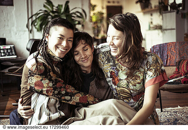 Young alternative female women friends laugh  smile and hug at home