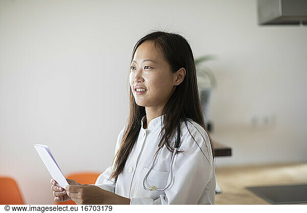 young asia female doctor with report in a practice