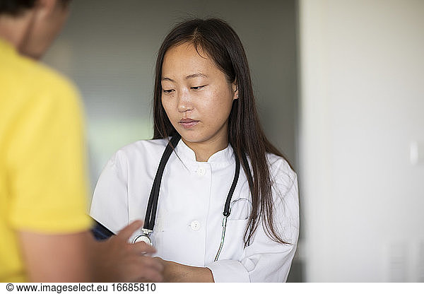 young asia female doctor woman with patientwith report in a practice