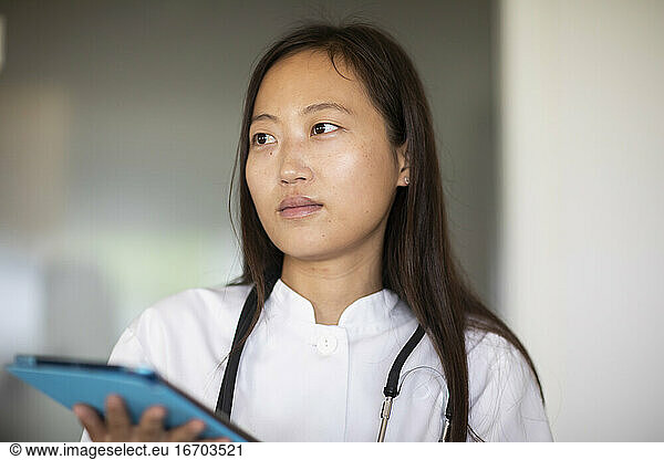 young asia female doctor woman with report in a practice