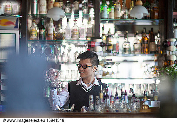 young asia waiter in a bar
