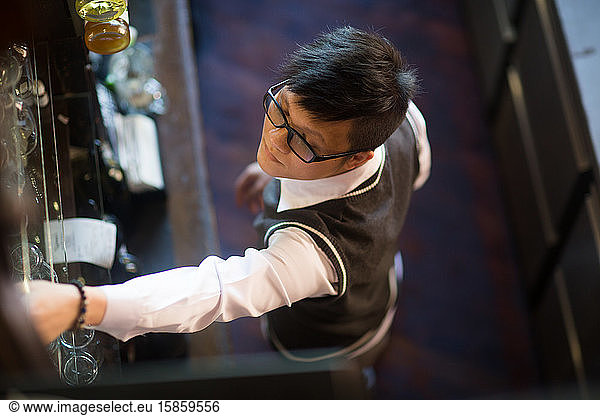 young asia waiter in a bar