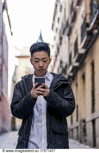 young asian man using his smartphone