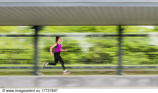 Young athlete running in sports park