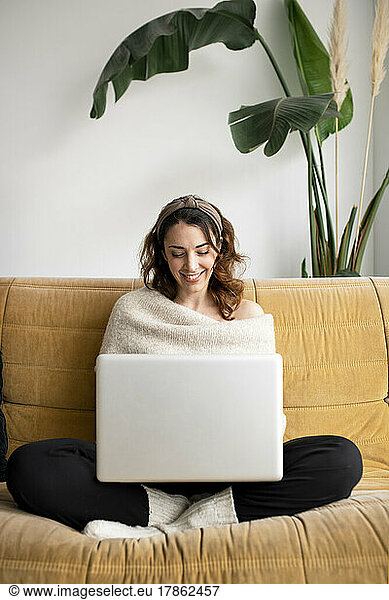 Young beautiful woman using a laptop at home