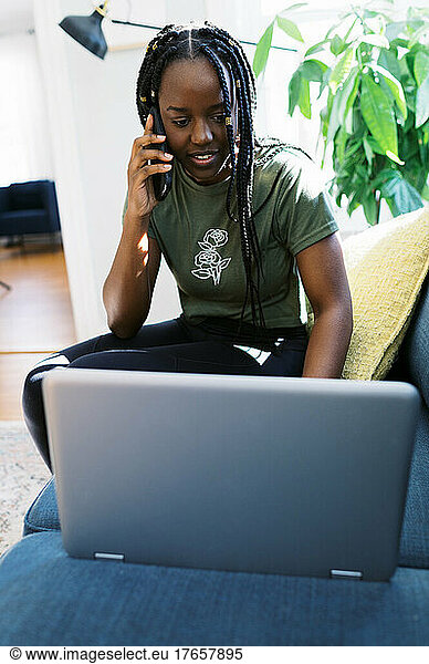 young black businesswoman working from home on laptop