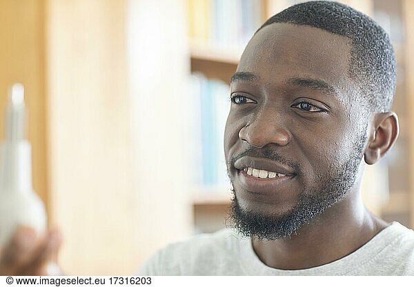 Young black man holding an idea as an invention  vision  innovation  Freiburg  Baden-Württemberg  Germany  Europe
