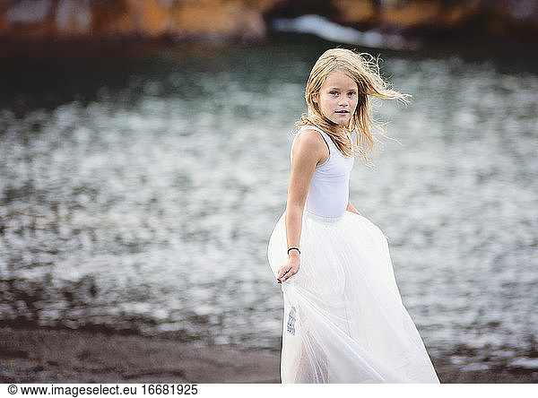 Young Blond Girl Dancing on Beach