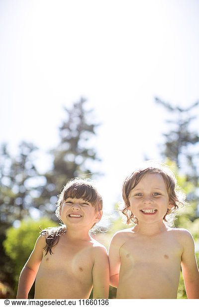 Young boy and girl  outdoors  smiling