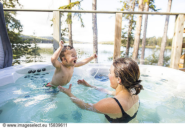 young boy enjoying a swim with his mother.