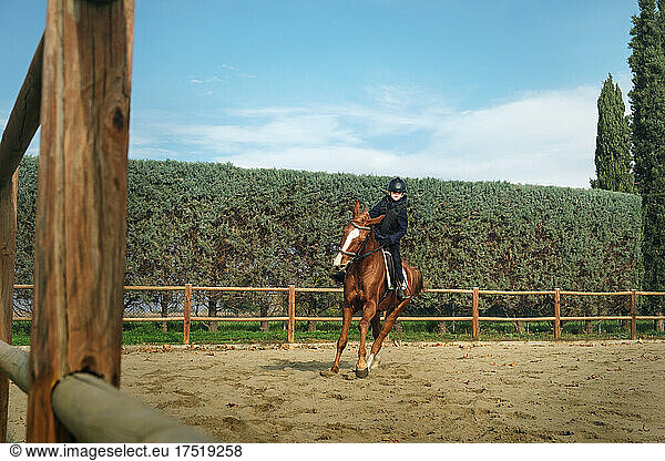 Young boy horseback riding at the ranch  gallop on a horse.
