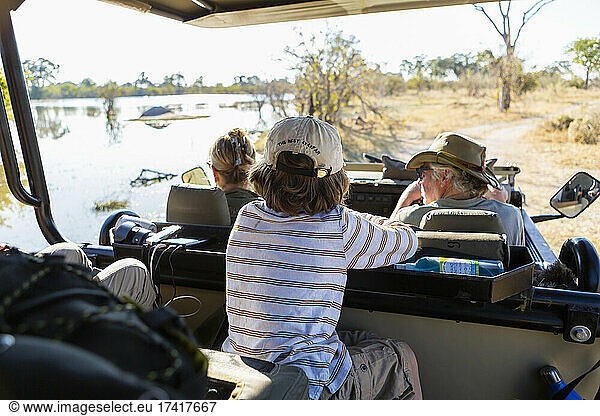 Young boy in safari vehicle at sunrise  Okavango Delta  Botswana.