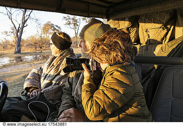 young boy photographing Okavango Delta  Botswana
