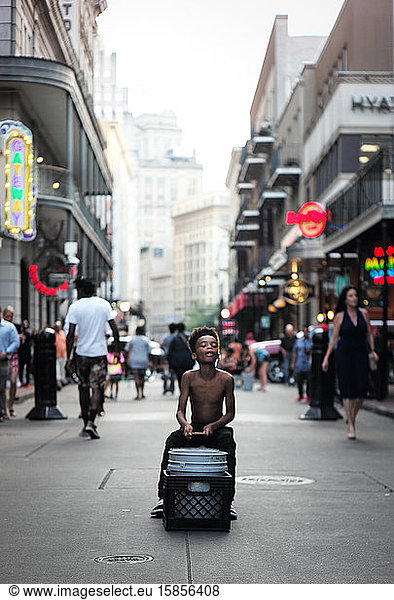 Young Boy Playing Drums In The Street