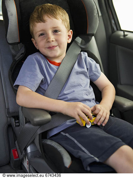 Young boy sitting in his car seat
