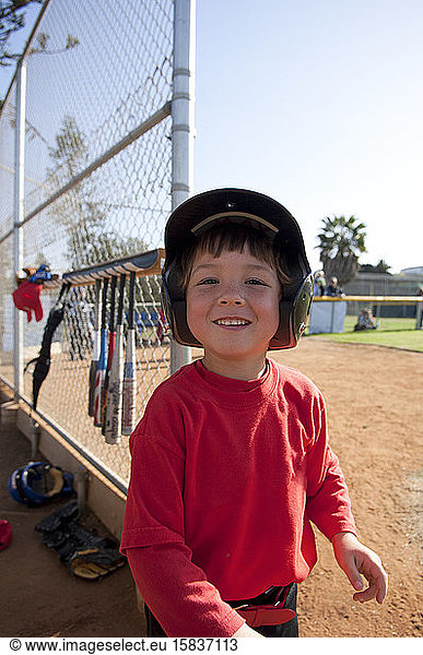 Young boy smiling near the TBall dugout