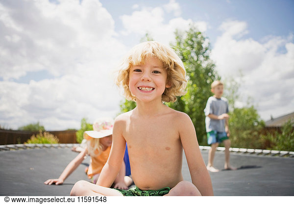 Young boy smiling on trampoline