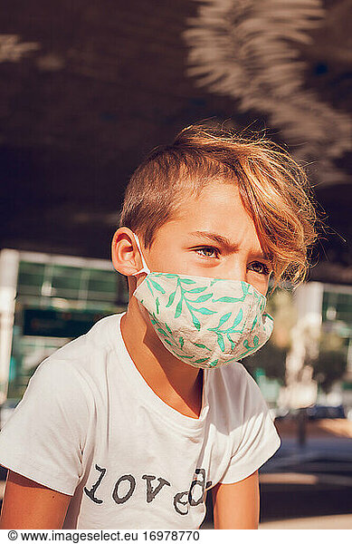 Young boy wearing a mask.