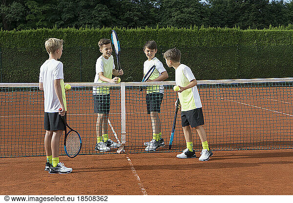 Young boys playing tennis on a sunny day  Bavaria  Germany