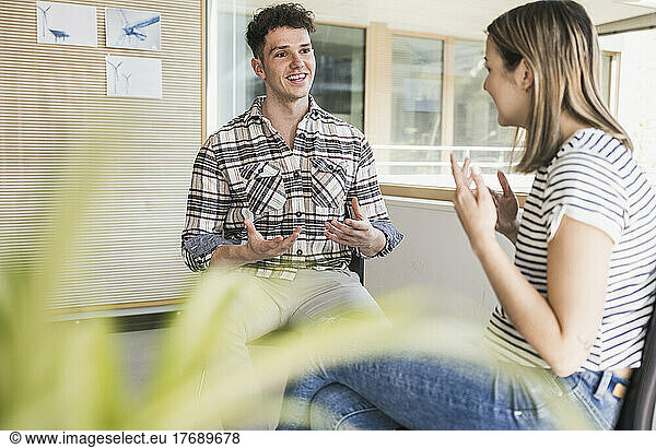 Young businessman and businesswoman having a meeting in office