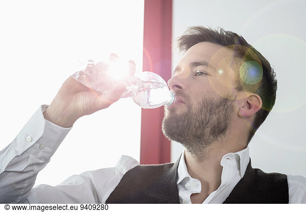 Young businessman thirsty drinking mineral water
