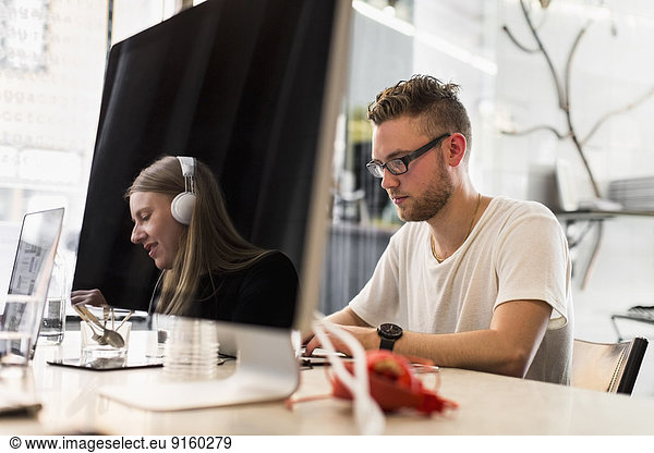 Young businessman working in new office