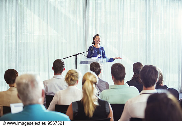 Young businesswoman giving presentation in conference room