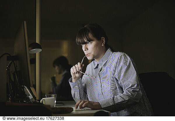 Young businesswoman using computer while working at work place