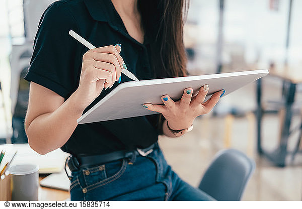 Young businesswoman using tablet searching infomation marketing