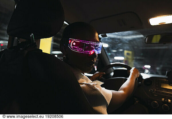 Young businesswoman wearing smart glasses and sitting in car