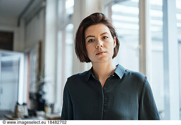 Young businesswoman with short hair in office