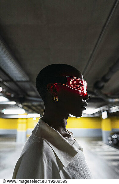 Young businesswoman with smart glasses in parking garage